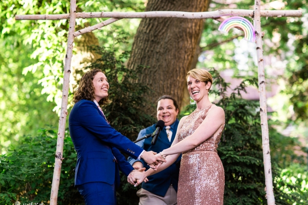 Candid photo of couple laughing during their summer wedding ceremony at Firehouse Chicago