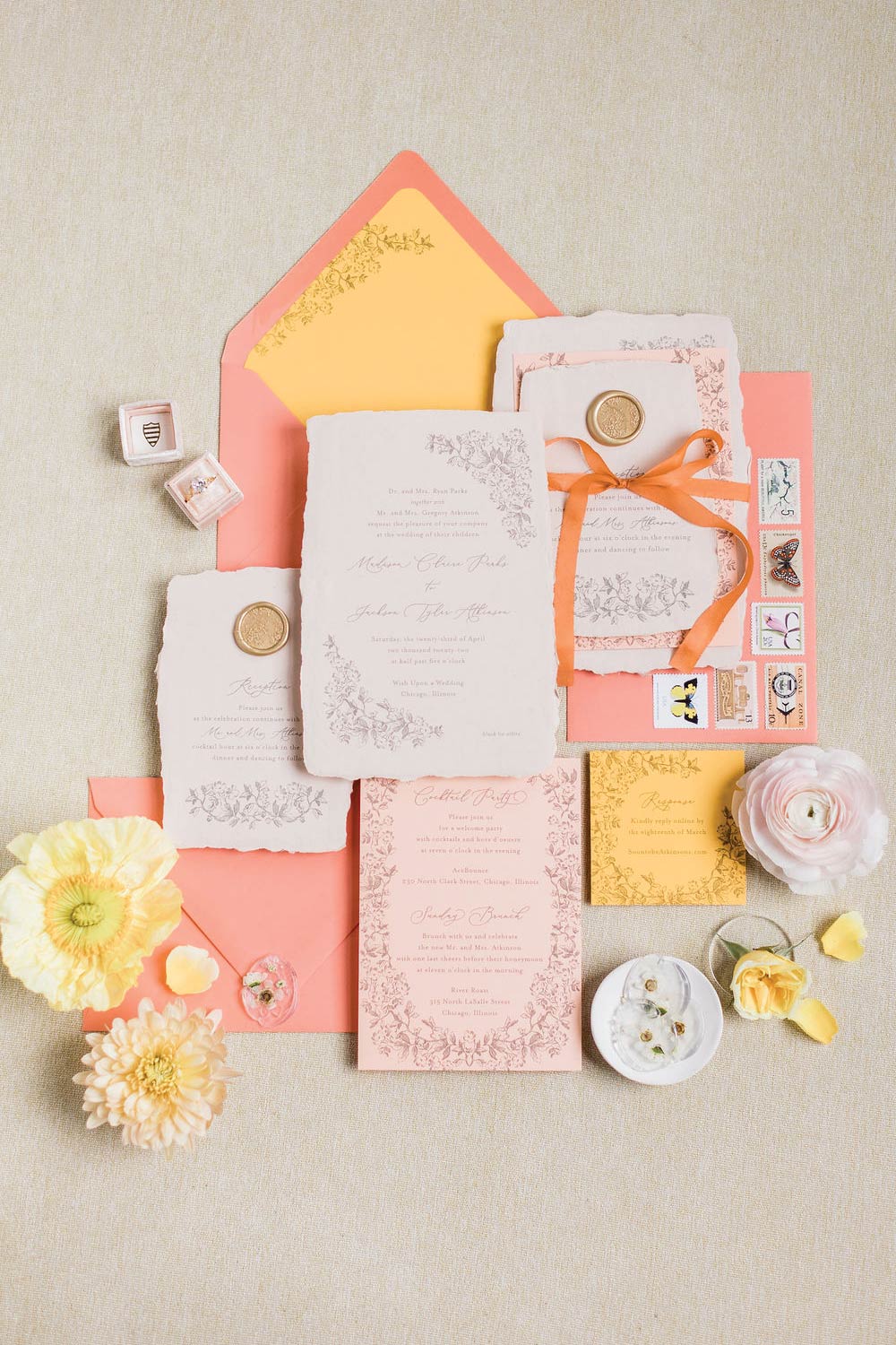 Handmade-paper-with-flower-illustrations-in-coral,-peach,-and-mustard-yellow-with-flower-wax-seal-and-ribbon