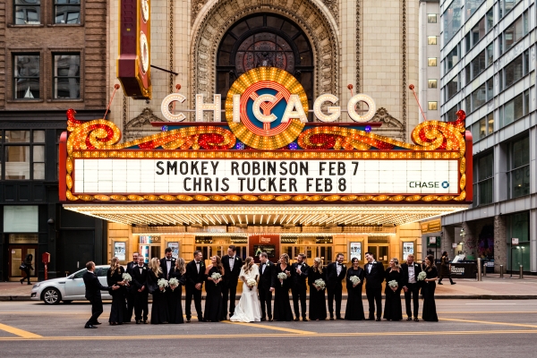 Chicago Theatre wedding party photo on State Street during winter wedding at Renaissance Chicago Downtown hotel