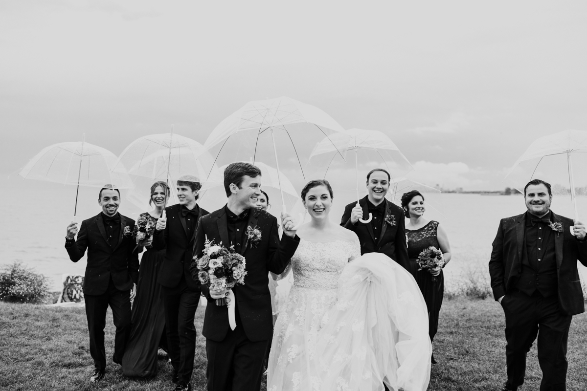 Wedding-party-with-umbrellas-by-Emma-Mullins-Photography