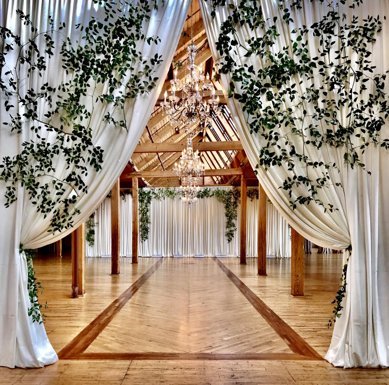 Full entrance drapery + wider backdrop with greenery