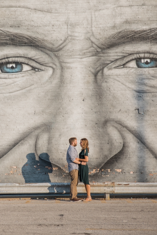 Couple in front of Robin Williams mural