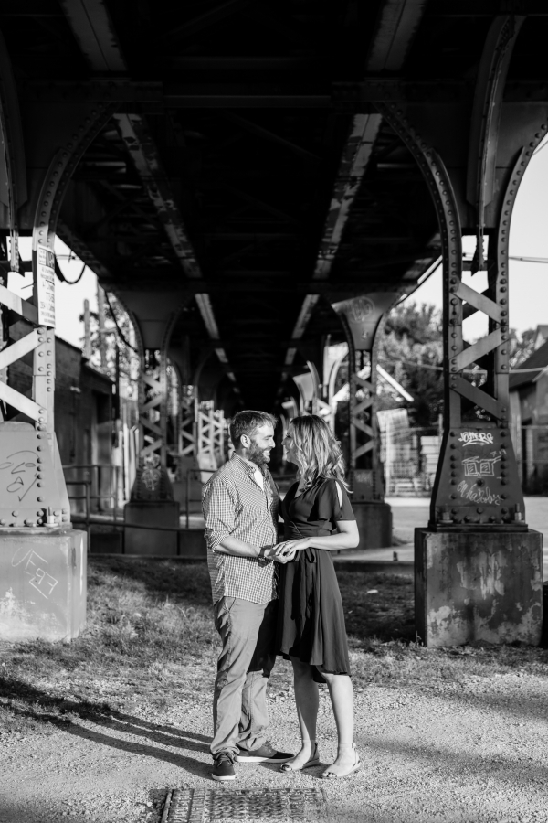 Couple laughing under El tracks