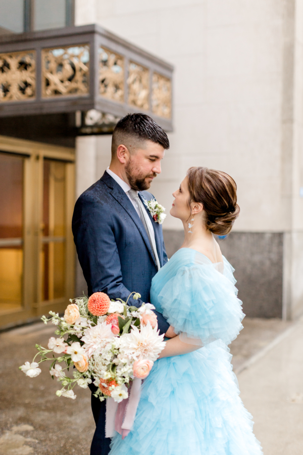 Blue Ruffles and Peach Flowers in Striking Elopement