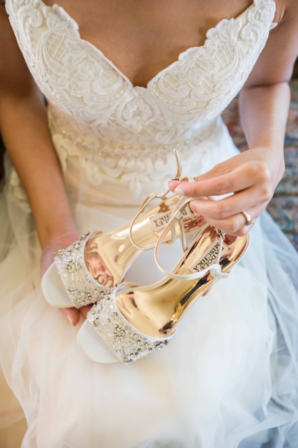 Bride getting ready at glessner House holding her wedding shoes.